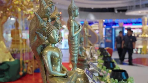 Small Buddha Dragon Statue, Indoor Buddhist Event, Teenagers Walk In Background Stock Footage 249971074