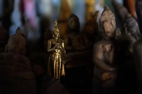 Small buddhist statues in a cave around the town Stock Photos