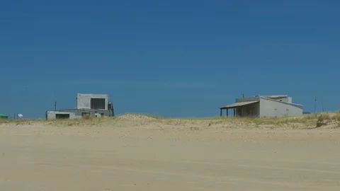 Small buildings facing the ocean in Cabo Polonio. Stock Footage 87721678