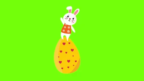 Small bunny peeking from top of large yellow easter egg Stock Footage 329585384