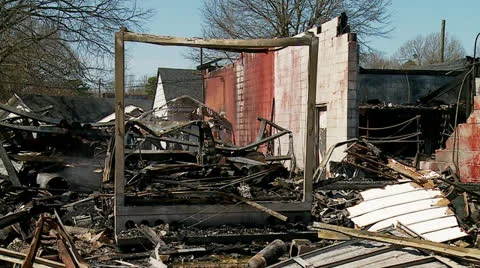 Small burned building with smoke Stock Footage 24691708