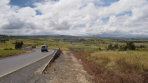A small bus drives down a road in a rural landscape in Ethiopia Stock Footage 74171390