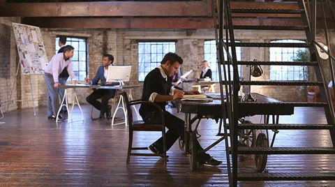 Small Business.  Casual downtown workers in chic loft or warehouse offices. Stock Footage