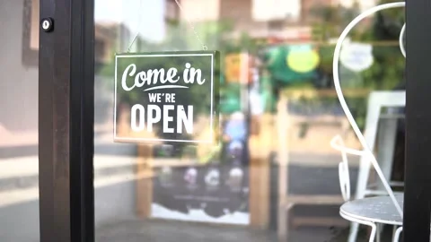 A small business closing down. Turning the sign from open to close. Stock Footage 137485353