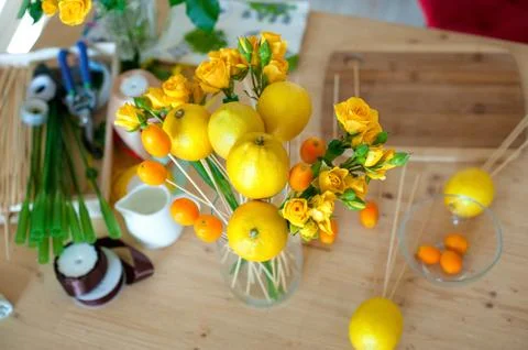 Small business concept. Work process of florist. bouquet of fruit and flowers Stock Photos