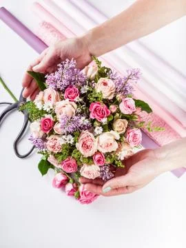 Small business concept. Work process of florist. Female hands making wedding  Stock Photos