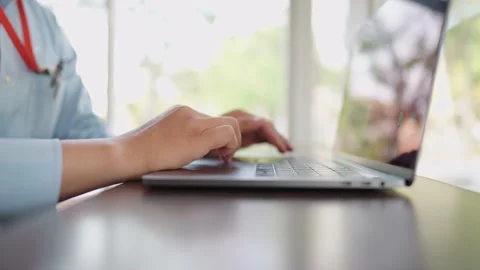 The small business manager is using a laptop to check stock. Stock Footage 147956762