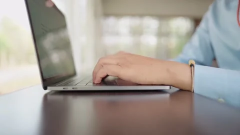 The small business manager is using a laptop to check stock. Stock-Footage 147956765