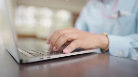 The small business manager is using a laptop to check stock. Stock Footage 147956769