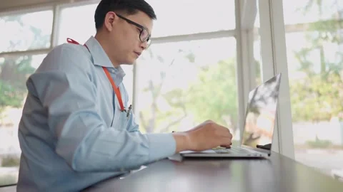 The small business manager is using a laptop to check stock. Stock Footage 147956773