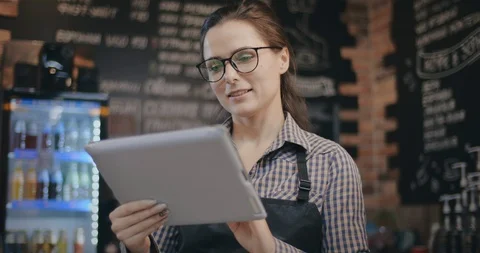 Small business owner holding tablet at counter in coffee shop Stock Footage