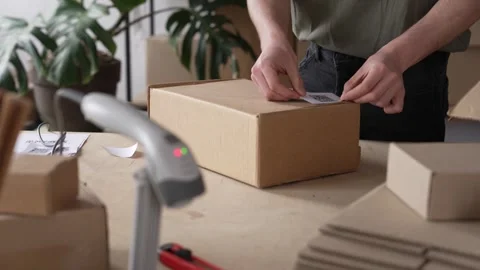 The small business owner marks the parcel with a QR code, packaging and sending Video stock 272392030