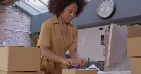 Small Business Owner Preparing Parcels using Smart phone 스톡 동영상 241823813