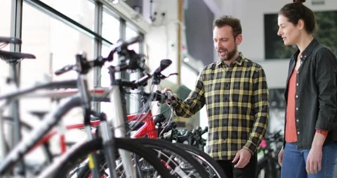 Small business owner serving customer in a bike store Stock Footage 87902456