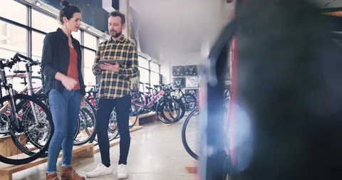 Small business owner serving customer in a bike store Stock Footage 87903676