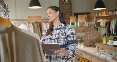 Small Business Owner using Digital tablet Technology in Store for Inventory Stock Footage 269501067