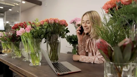 Small Business Owner Using Smartphone and Laptop In A Shop. Slow Mo Stock Footage 124522899