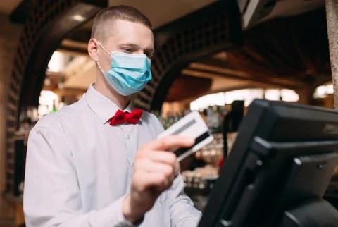 Small business, people and service concept. man or waiter in medical mask at Stock Photos