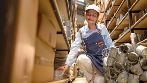 Small business worker carefully inspecting products in a warehouse Stock Footage 339642238