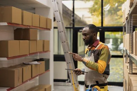 Small business worker checking inventory and preparing parcels for delivery Stock Photos