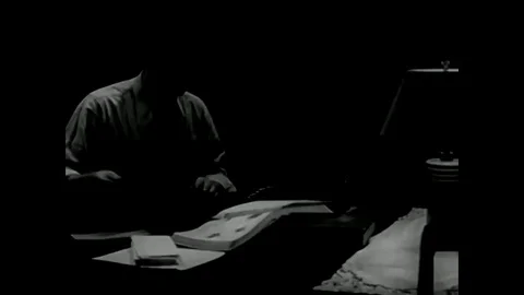 A small businessman writes a check in his home, in Elmville, Ohio, in 1947. Stock Footage 79517561