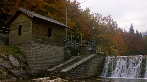 Small cabin by a waterfall Stock Footage 258957578