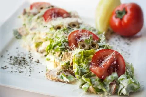 A small caesar salad with shredded parmesan cheese, croutons and tomatos Stock Photos