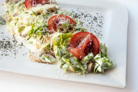 A small caesar salad with shredded parmesan cheese, croutons and tomatos Stock Photos