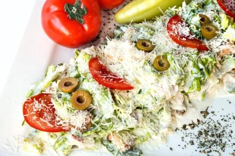 A small caesar salad with shredded parmesan cheese, croutons and tomatos Stock Photos