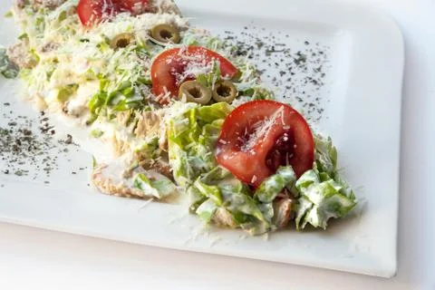 A small Caesar Salad with shredded parmesan cheese, croutons and Stock Photos