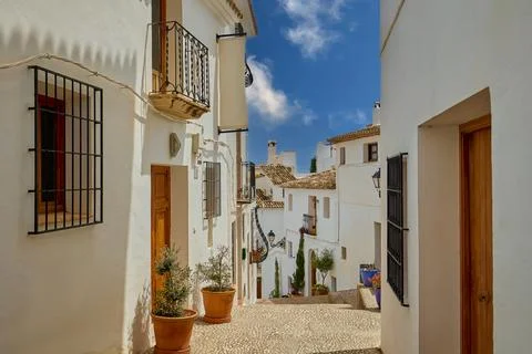 A small cafe without people on a narrow street of the old town. Stock Photos