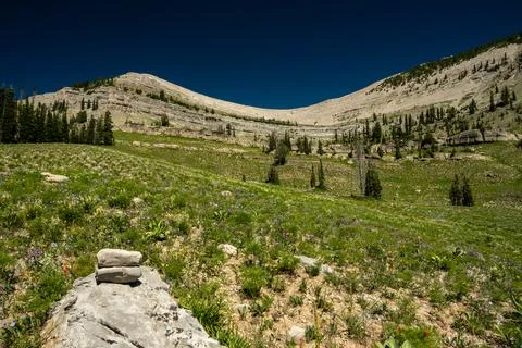 Small Cairn Sits Below The Sweeping Ridge Over Moose Basin In Grand Teton 写真素材