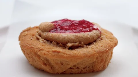 Small cake with fruit topping pouring on it Stock Footage 108312671