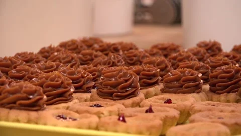 Small Cakes being prepared by a professional in a bakery Stock Footage 239696146