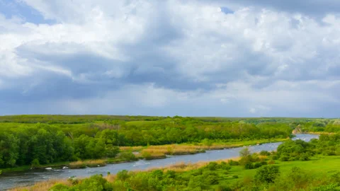Small calm river flow among green hills under cloudy sky Stock-Footage 314310374
