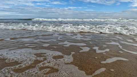Small calm sea waves at San Juan Playa, beach coastline, low level video Stock Footage 229619587