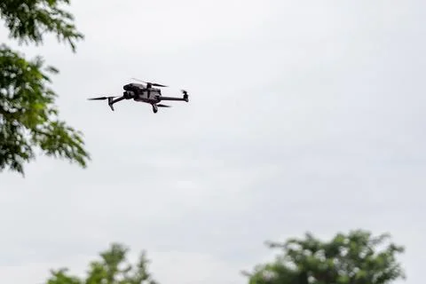 Small Camera Drone Flying Against Overcast Sky Stock Photos