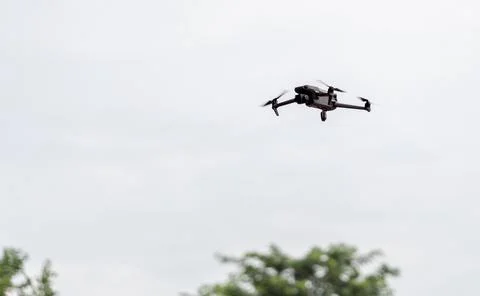 Small Camera Drone Flying Against Overcast Sky Stock Photos
