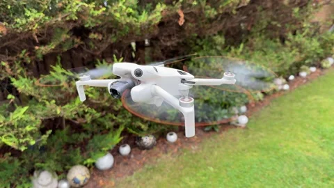 Small Camera Drone Flying Close Up with Quadcopter Propellers and Gimbal Visible Stock-Footage 345170435