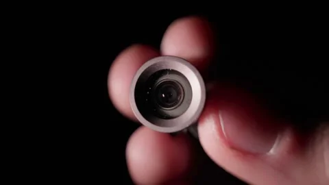 A small camera module in the hands disappears in the dark Stock Footage 170681733