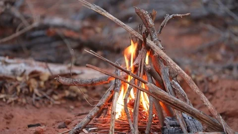 Small camp fire burning in dry landscape of Botswana Video stock 113965576