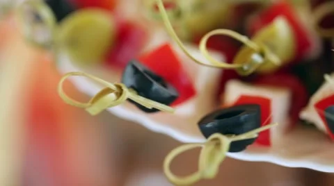 Small canape with olives, cheese, cherry tomatoes and cucumber close-up Stock Footage 66557935