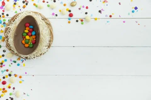 Small candies open easter chocolate egg table Stock Photos