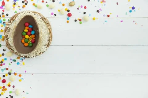 Small candies open easter chocolate egg table Stock Photos