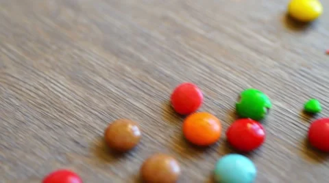 Small candies on wooden table Video stock 42644792