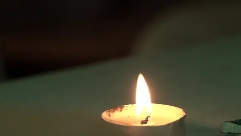 A small candle is burning on the table Video stock 123005586