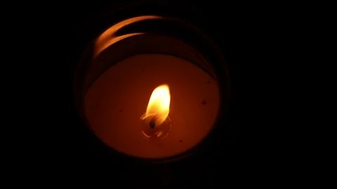 Small candle flame burning in darkness Stock Footage 318852488