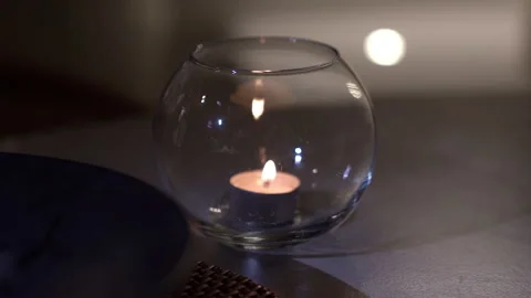 Small candle standing on stone table Stock Footage 273380814