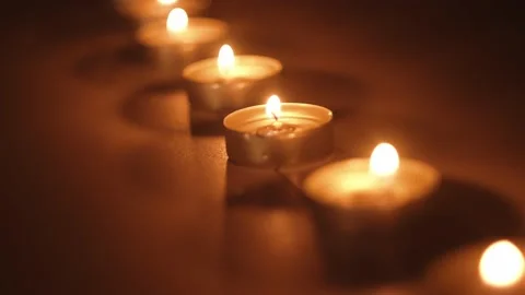 Small candles fire on table closeup Stock Footage 159550757