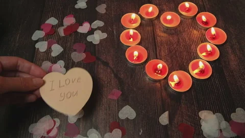Small candles on the table with love letter I love you and confetti hearts Stock Footage 280209792